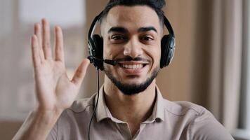Smiling male operator hispanic businessman customer support service assistant representative greeting speak at web camera wear headset with microphone make conference call remote job interview photo