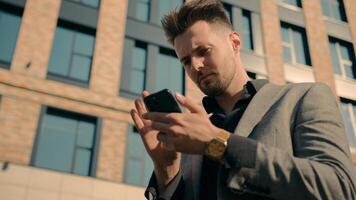 Pensive thoughtful Caucasian male guy businessman business man looking around outdoors using direction smartphone in city downtown searching location geolocation maps gps application on mobile phone photo