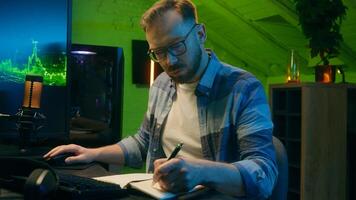 Focused serious Caucasian man freelancer male modern guy working writing results programmer crypto analyst typing keyboard computer pc concentration e-commerce home neon night trading stock deadline photo
