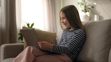 Little girl using laptop desktop computer pc technology gadget child daughter preteen texting typing device cyberspace kid networking home funny communicating browse virtual e-learning online educate photo