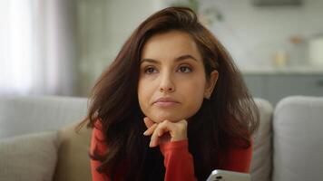 Bored thoughtful Caucasian female tired woman girl client user boredom typing message chatting using mobile phone scrolling social media boring online app thinking problem solution at home living room photo