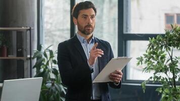 Focused caucasian businessman developer with paper tablet write notes data in note tablet writing to-do list business ideas pensive man HR manager recruiter planning workflow create plan in office photo