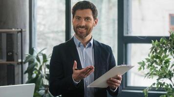 Caucasian male businessman employer HR manager recruiter candidate employee consultant manager write questionnaire man developer planning workflow creating plan in office writing notes in note tablet photo