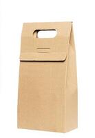 Paper food box packaging mockups brown color. Blank craft folding bag mockup, side view. Carton bottle package with handle for carrier mockup isolated. Clear disposable paperboard holder photo