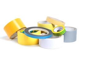 A heap of packing tape and a masking tape isolated on white background, with clipping path. adhesive tape. Scotch tape. photo