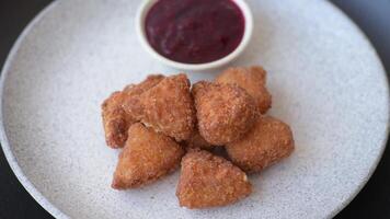 Brie cheese or camembert fries in breading, fast food, takeaway on a dark concrete background video