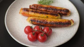Chicken or pork sausages with salt, spices and herbs on a dark concrete background video