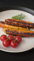 Chicken or pork sausages with salt, spices and herbs on a dark concrete background video