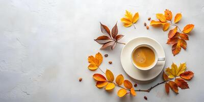 Coffee Cup on Saucer Surrounded by Branches with Orange Leaves. Empty Space on the Left Side for Text photo