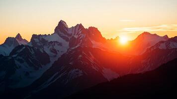 Towering mountains with snowy peaks bathed in the warm light of sunrise, casting long shadows and illuminating the sky with hues of pink, orange, and gold. photo