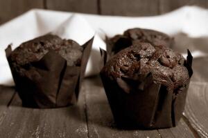 Chocolate muffins on wood background photo
