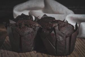 Chocolate muffins on wood background photo