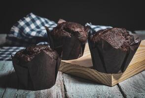 Chocolate muffins on wood background photo