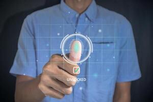 Man unlock and access to personal data by scanning fingerprint on virtual screen photo