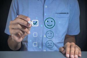 Man gives rating to service experience on virtual screen. Customer review satisfaction feedback concept. photo