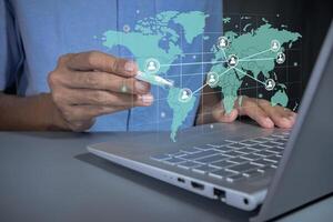 Man with global communication network on virtual screen. Global business or worldwide business concept. photo