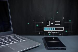 Transfer files from mobile phone to laptop. Backup, Copy file and media or exchange data concept. photo