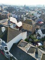 High Angle View of Historical Central Eastbourne Buildings and City of England, United Kingdom. Aerial Footage Was Captured with Drone's Camera During Windy Day on May 11th, 2024 photo