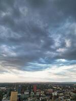 Aerial View of Greater Manchester City Centre and Tall Buildings During Golden Hour of Sunset. England UK. High Angle Footage Was Captured with Drone's Camera During Windy day of May 5th, 2024 photo