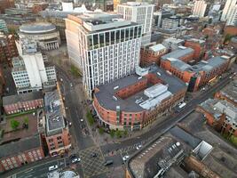 Aerial View of Greater Manchester City Centre and Tall Buildings During Golden Hour of Sunset. England UK. High Angle Footage Was Captured with Drone's Camera During Windy day of May 5th, 2024 photo