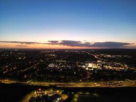 Most Beautiful High Angle View of Illuminated Luton City of England UK at Just After Sunset and Full Moon Night. Aerial Footage Was Captured with Drone's Camera on October 17th, 2024 photo
