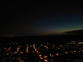 Most Beautiful High Angle View of Illuminated Luton City of England UK at Just After Sunset and Full Moon Night. Aerial Footage Was Captured with Drone's Camera on October 17th, 2024 photo