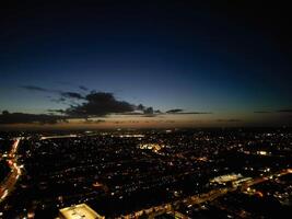 Most Beautiful High Angle View of Illuminated Luton City of England UK at Just After Sunset and Full Moon Night. Aerial Footage Was Captured with Drone's Camera on October 17th, 2024 photo