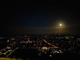 Most Beautiful High Angle View of Illuminated Luton City of England UK at Just After Sunset and Full Moon Night. Aerial Footage Was Captured with Drone's Camera on October 17th, 2024 photo