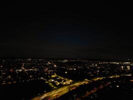 Most Beautiful High Angle View of Illuminated Luton City of England UK at Just After Sunset and Full Moon Night. Aerial Footage Was Captured with Drone's Camera on October 17th, 2024 photo