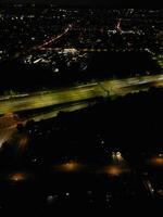 Most Beautiful High Angle View of Illuminated Luton City of England UK at Just After Sunset and Full Moon Night. Aerial Footage Was Captured with Drone's Camera on October 17th, 2024 photo