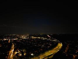 Most Beautiful High Angle View of Illuminated Luton City of England UK at Just After Sunset and Full Moon Night. Aerial Footage Was Captured with Drone's Camera on October 17th, 2024 photo