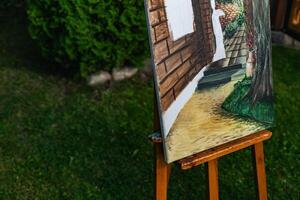 Close-up of someone skillfully painting on a canvas. The artwork looks like it depicts a rustic scene, possibly featuring elements like bricks or wood, giving it a cozy, homely feel. photo