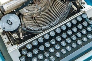 Vintage typewriter with a close-up on the keyboard. The keys are worn and dusty, suggesting years of use. photo