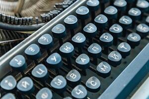 Vintage typewriter with a close-up on the keyboard. The keys are worn and dusty, suggesting years of use. photo