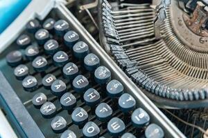 Vintage typewriter with a close-up on the keyboard. The keys are worn and dusty, suggesting years of use. photo