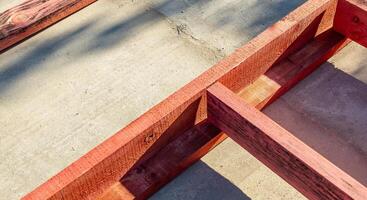 Close-up of a wooden frame for a new construction project. The frame rests on a concrete foundation. Construction of a wooden frame house. photo