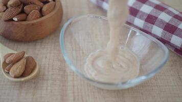 fresh almond yogurt in a bowl on table video