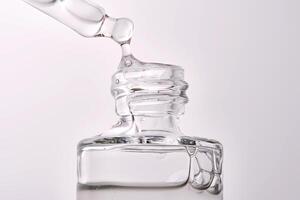 Close-up of a cosmetic bottle with a pipette showing the texture of the serum. photo