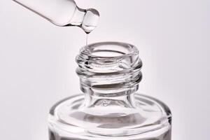 Close-up of a cosmetic bottle with a pipette showing the texture of the serum. photo
