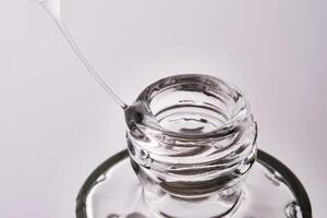 Close-up of a cosmetic bottle with a pipette showing the texture of the serum. photo