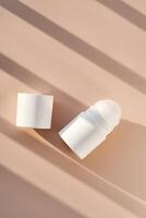 Roll-on deodorant on a purple background with shadow stripes. photo