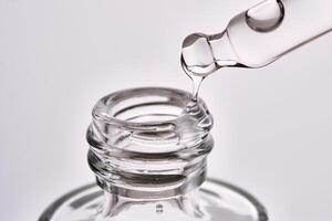 Close-up of a cosmetic bottle with a pipette showing the texture of the serum. photo
