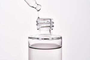 Close-up of a cosmetic bottle with a pipette showing the texture of the serum. photo