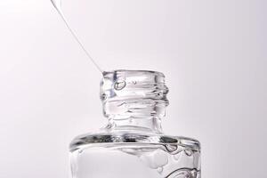 Close-up of a cosmetic bottle with a pipette showing the texture of the serum. photo