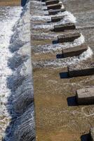 chute dentate blocks in concrete water spillway channel photo