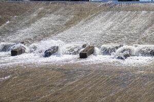 chute dentate blocks in concrete water spillway channel photo