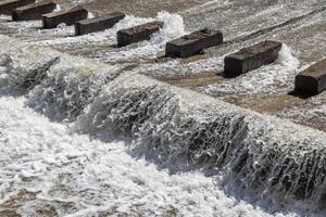 chute dentate blocks in concrete water spillway channel photo