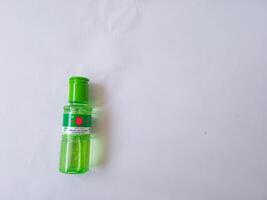 Surabaya, Indonesia - 19 October 2024 Cap lang. Eucalyptus oil. Cajuput oil. Helps relieve stomach aches, flatulence, nausea, and itching due to insect or mosquito bites. isolate on white photo