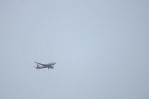 Solitary Airplane in Clear Sky photo