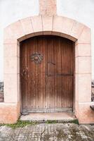 a wooden door in a white building. Aribe , Navarra photo